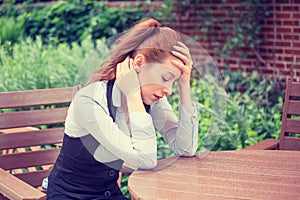 Portrait stressed sad young woman outdoors. Urban life style stress