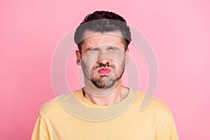 Portrait of stressed strained handsome man stylish haircut yellow t-shirt holding breath eyes closed isolated on pink