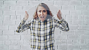 Portrait of stressed young woman screaming and gesturing expressing negative emotions then going away upset and angry