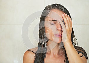 Portrait of stressed young woman in shower