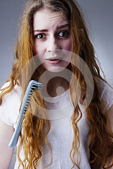 Portrait of a stressed young woman with tousled and disheveled l