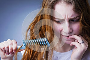 Portrait of a stressed young woman with tousled and disheveled l