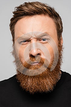 portrait of stringent bearded man frowning photo