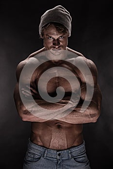 Portrait of strong Athletic Fitness man over black background