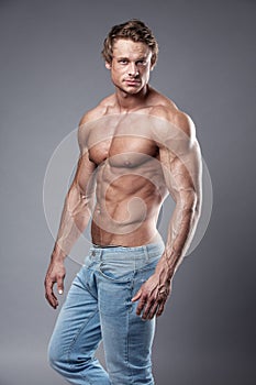 Portrait of strong Athletic Fitness man over grey background