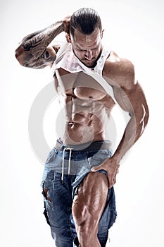 Portrait of strong Athletic Fitness man showing big muscles