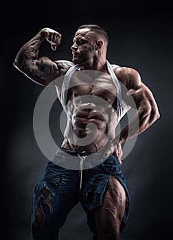 Portrait of strong Athletic Fitness man showing big muscles