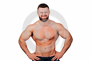 Portrait of a strong bearded male fitness model, torso. White background, isolate. hands on his hips.