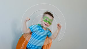 Portrait of a strong confident boy in a superhero costume Looking camera showing biceps. success concept. happy