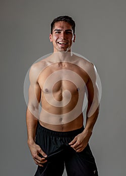 Portrait of strong healthy handsome Athletic man isolated on neutral background
