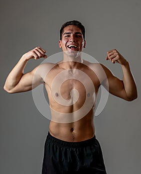 Portrait of strong healthy handsome Athletic man isolated on neutral background