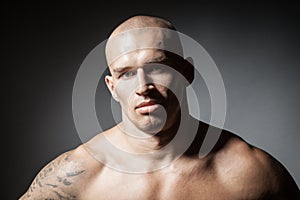 Portrait of strong man isolated on dark