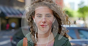 Portrait of a student with a cool attitude, listening to music with earphones in urban city. Modern closeup face of