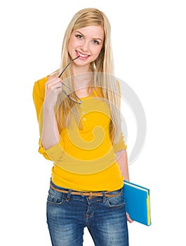 Portrait of student girl with book and glasses