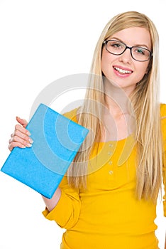 Portrait of student girl in glasses holding book