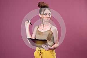 Portrait of student girl with pen and paper folder. Young pretty worker writing something in her papers