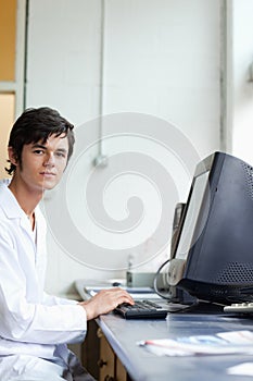 Portrait of a student posing with a monitor