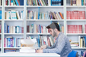 Portrait of student while reading book in school library