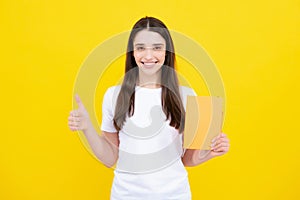 Portrait of student woman. College or high school ducation. Young woman with notebooks smiling at camera on yellow