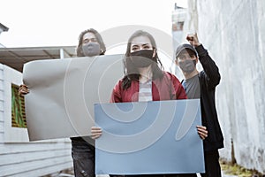 Portrait students holding blank paper conducting demonstrations