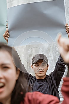 Portrait students holding blank paper who are burning with enthusiasm