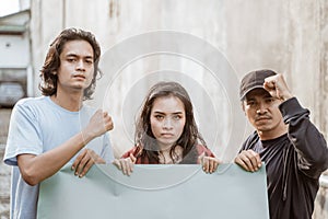 Portrait students holding blank paper who are burning with enthusiasm