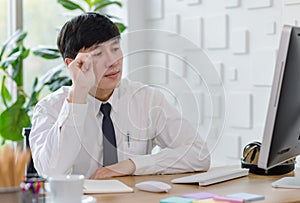 Portrait studio shot of Asian professional successful male businessman employee in formal shirt with necktie sitting look at