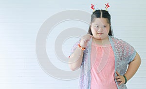 Portrait studio shot of Asian young cute chubby female down syndrome autistic model wear red dear antlers headband and casual