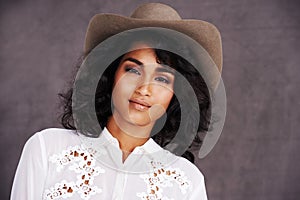 Portrait, studio and woman with cowgirl fashion, confidence and relax with girl in stetson hat. Rodeo, western style and