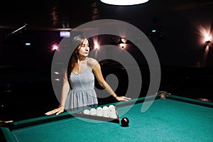 Portrait of a stunning woman and billiards table