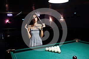 Portrait of a stunning woman and billiards table