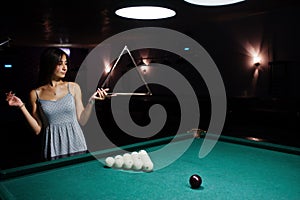 Portrait of a stunning woman and billiards table