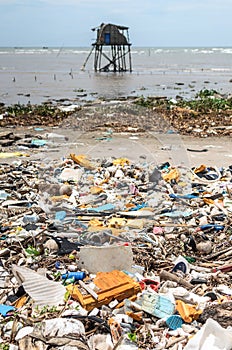 Portrait style shot of Vietnamese coastline covered in trash and garbage photo