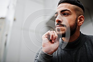 Portrait of stylish arab beard man wear grey turtleneck. Arabian model guy against steel wall