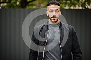 Portrait of stylish arab beard man wear grey turtleneck and black jaket. Arabian model guy