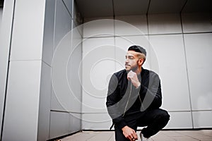 Portrait of stylish arab beard man wear grey turtleneck and black jaket. Arabian model guy against steel wall