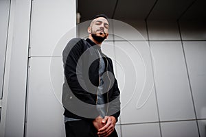 Portrait of stylish arab beard man wear grey turtleneck and black jaket. Arabian model guy against steel wall