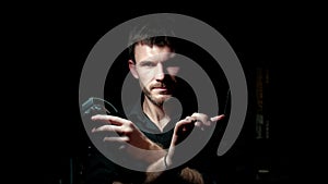 Portrait of stylish barber with beard and professional tools isolated on a dark background.