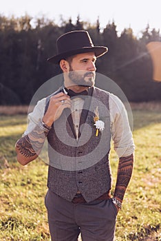 Portrait of stylish beard, male with tattoos on his arms. Wedding portrait photo