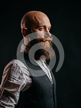 Portrait of a stylish bearded man on a black background