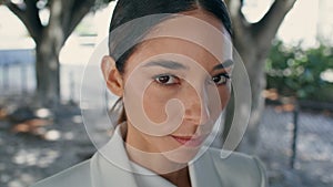 Portrait stylish business lady looking camera in white suit. Trendy woman posing