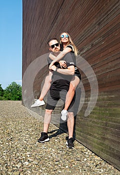 Portrait of stylish confident young couple models in sunglasses