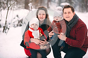 Portrait of a stylish family having a good time in the winter forest. decorated place to relax.