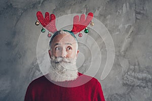 Portrait of stylish funky old man in reindeer headband enjoy christmas party x-mas celebration wear red modern sweater