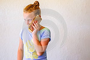 Portrait Of Stylish Girl In Blue Color T-shirt Using Smartphone.