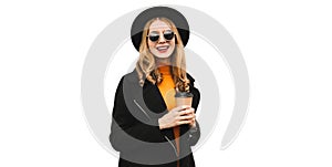 Portrait of stylish happy smiling young woman with cup of coffee wearing black coat, round hat isolated on white background