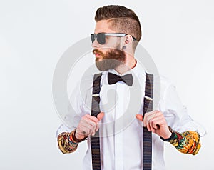 Portrait of a stylish hipster holding his suspenders