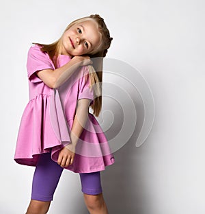 Portrait of a stylish little girl in summer clothes on a white background.