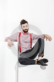 Portrait of stylish man in red suspenders and bow-tie