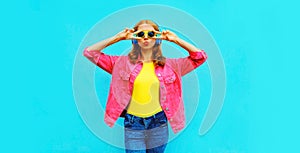 Portrait of stylish modern young woman in headphones listening to music blowing her lips sends sweetr kiss wearing pink jacket photo